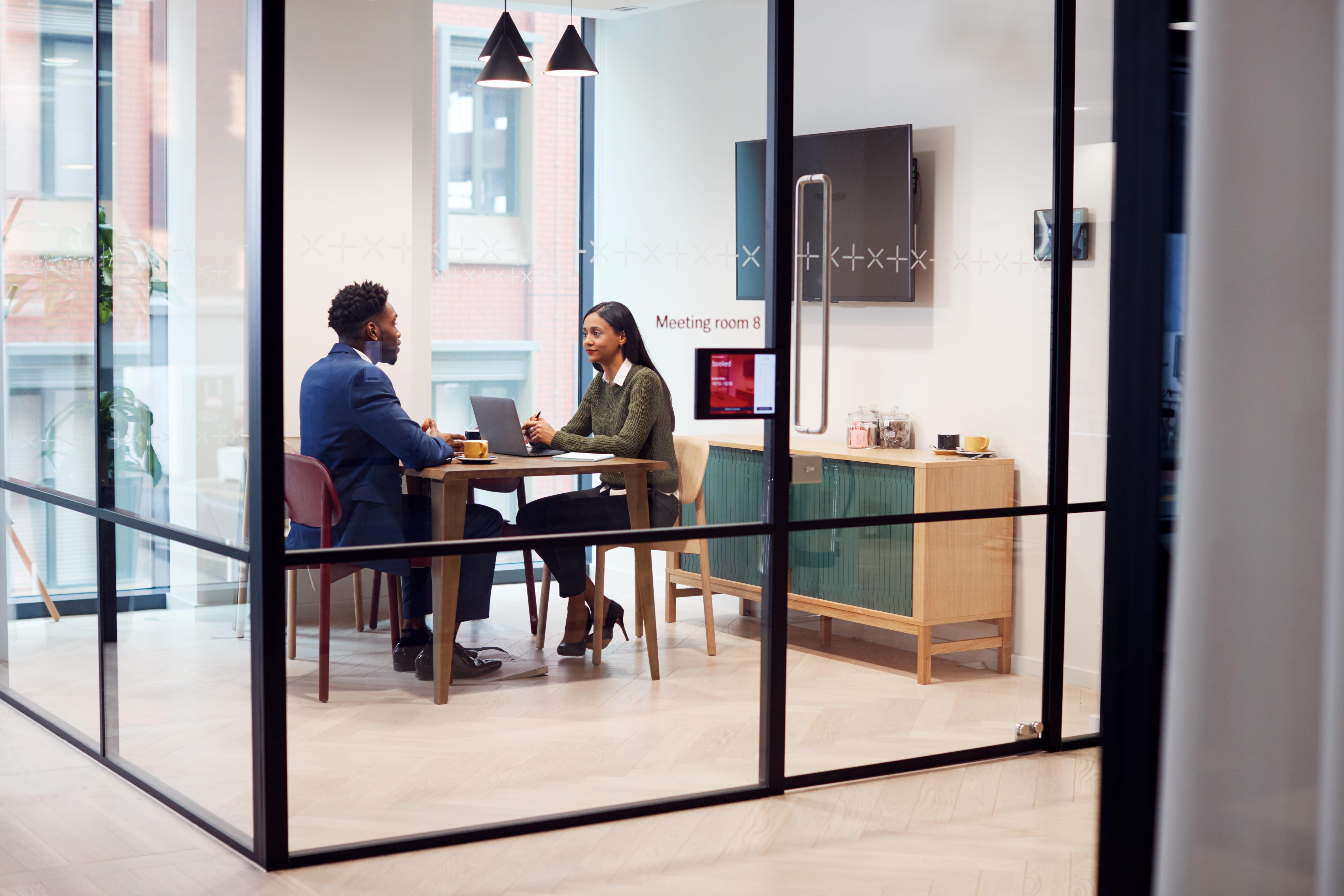 Businesswoman Interviewing Male Job Candidate In Meeting Room Businesswoman Interviewing Male Job Candidate In Meeting Room