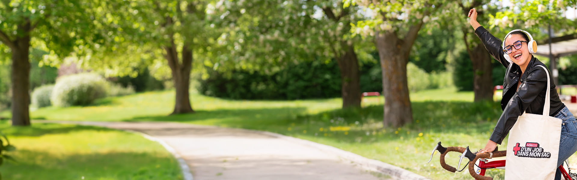 Une candidate Adecco souriante sur un vélo Une candidate Adecco souriante sur un vélo