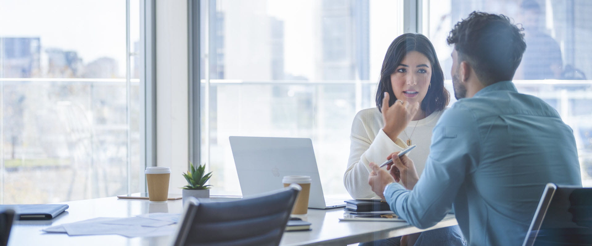 Business woman and man meeting in a conference room and talking