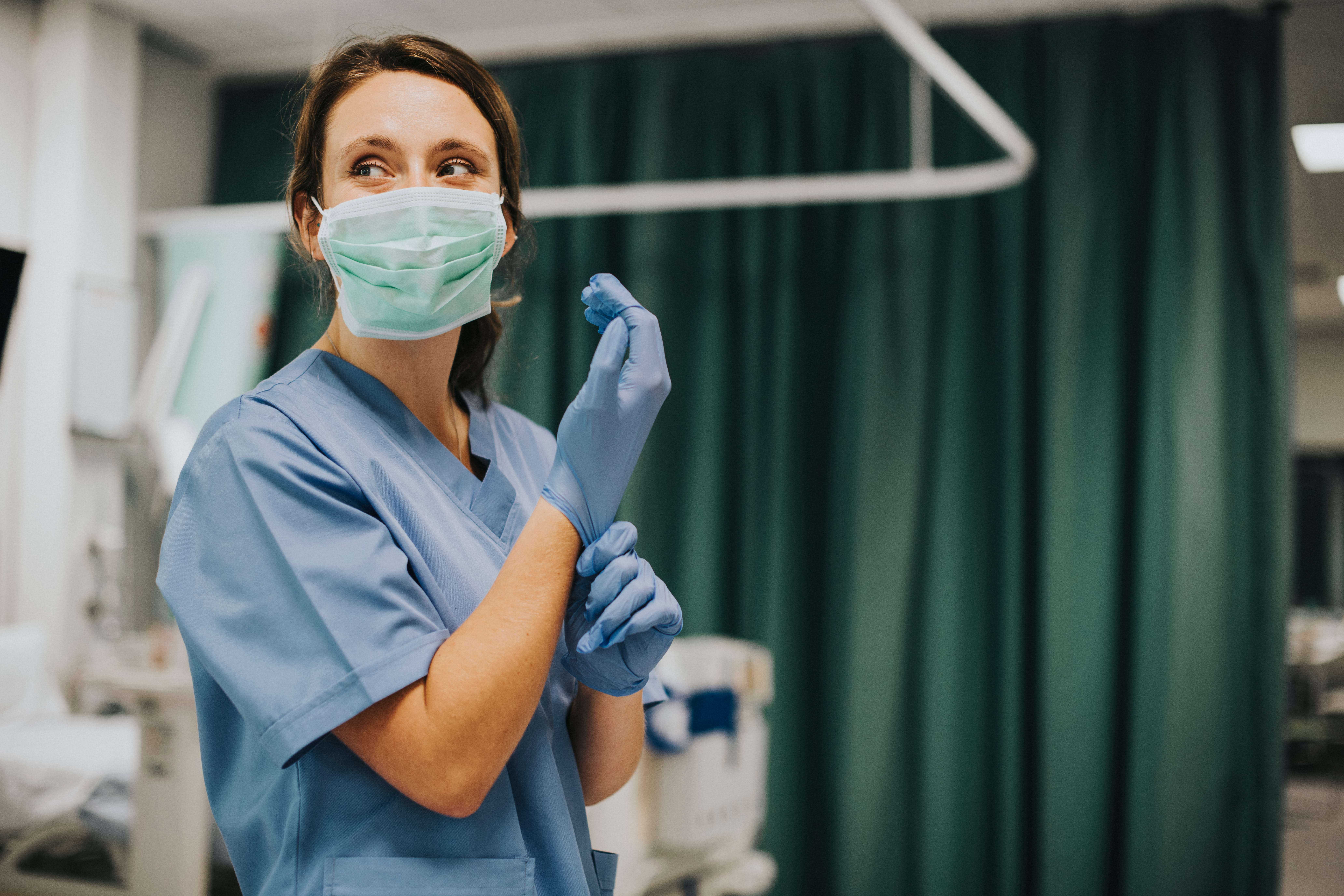 medical professional wearing scrubs mask and gloves medical professional wearing scrubs mask and gloves