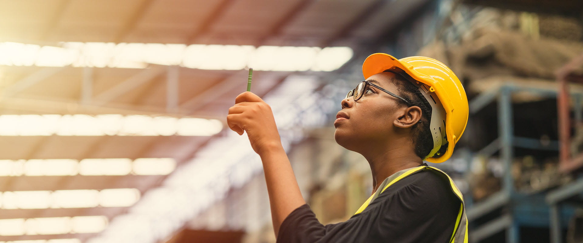 working in warehouse wearing hardhat working in warehouse wearing hardhat